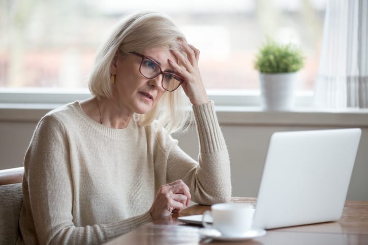 Confused Senior Woman Looking at Laptop
