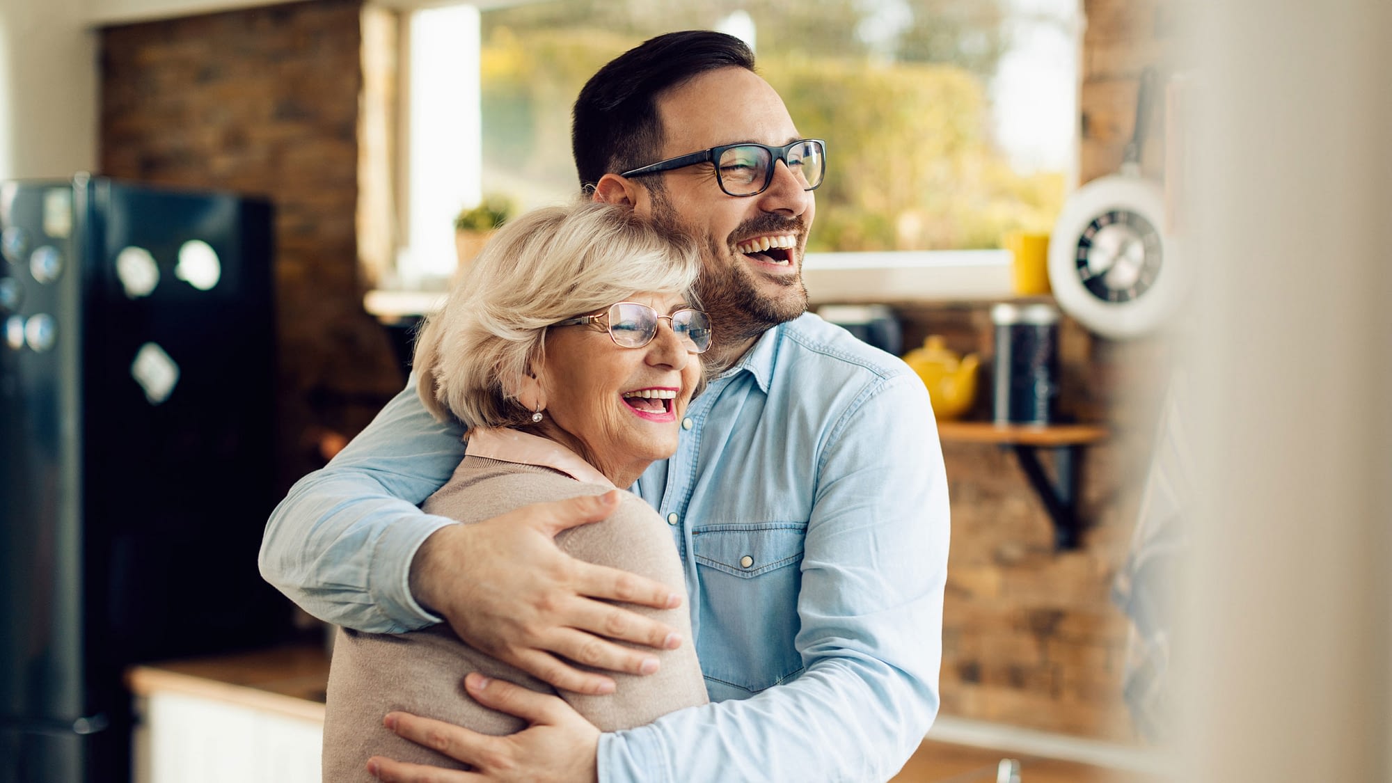 Happy senior mother and son embrace.