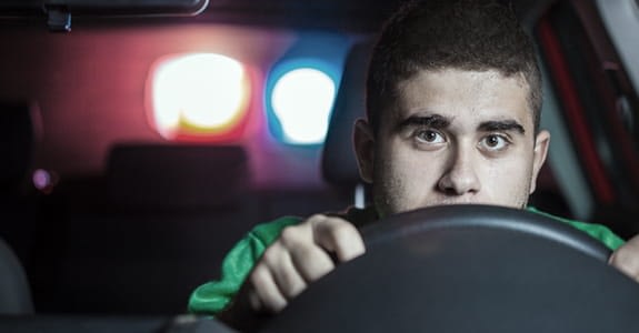 man_getting_pulled_over_by_cop_car_575x300