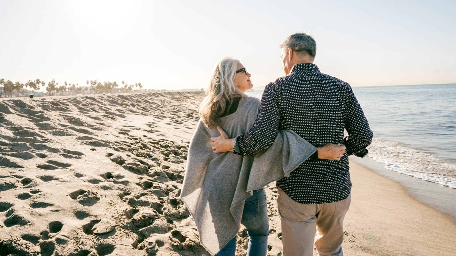 Senior couple walking on the beach Happy couple on the beach together