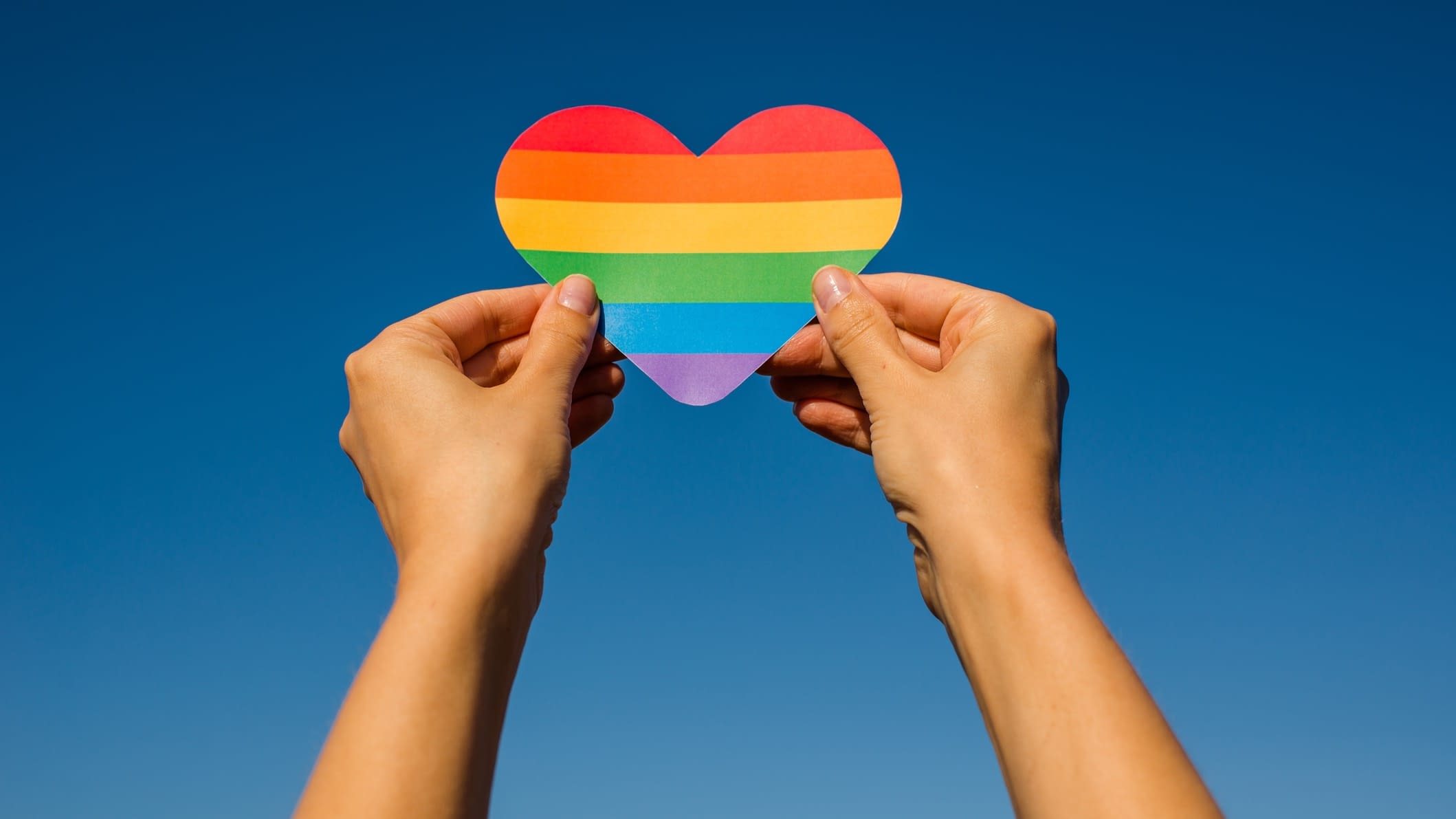 Colorful heart Person holding pride heart
