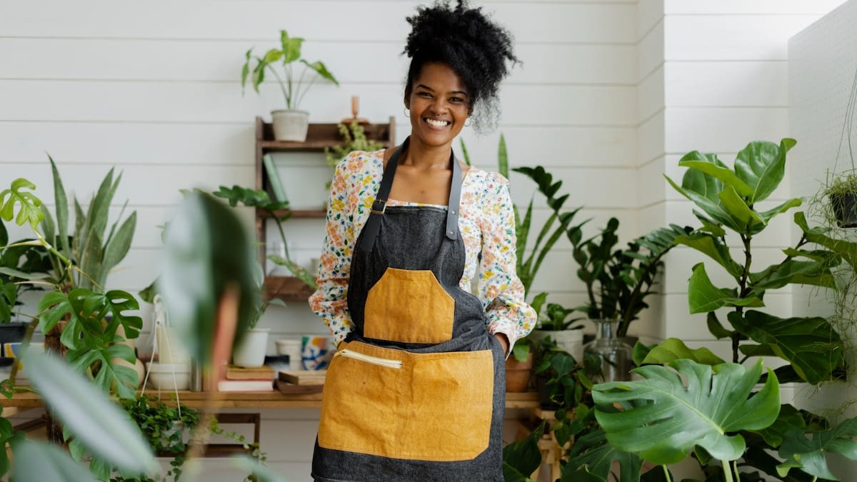 Business owner in plant store Woman standing in plant shop