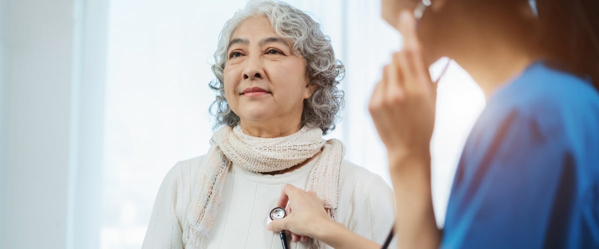 Older woman getting heart checked at wellness visit.