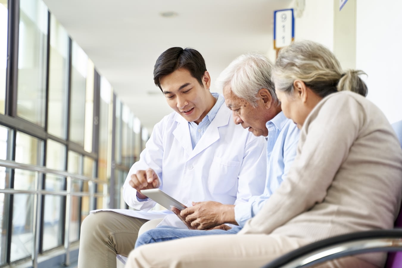 Senior couple talking with medical professional