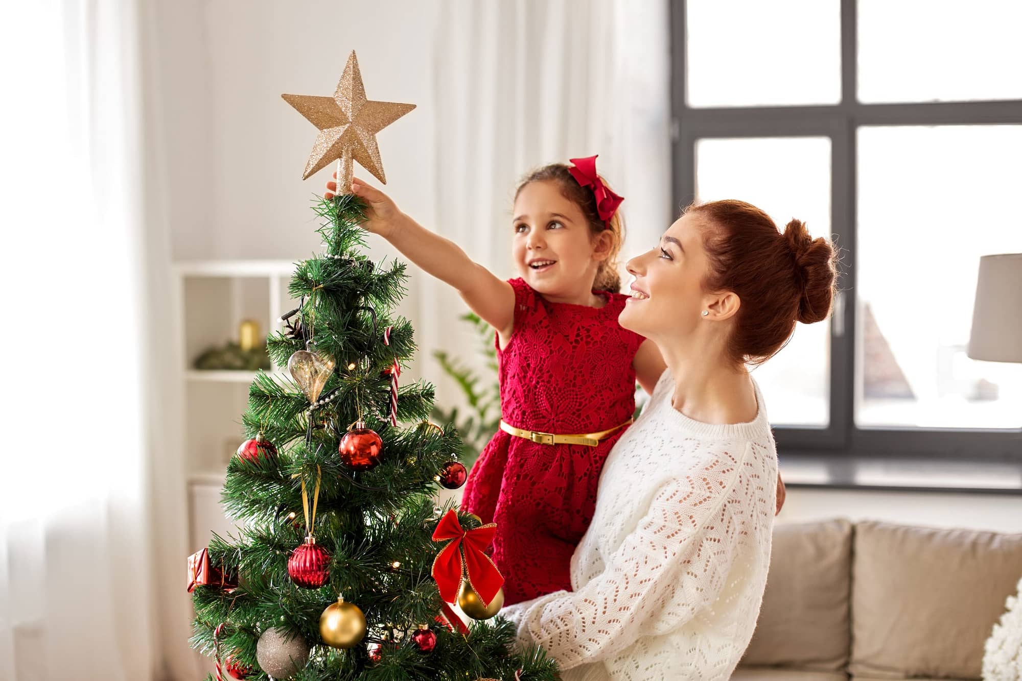 mother and daughter decorating tree