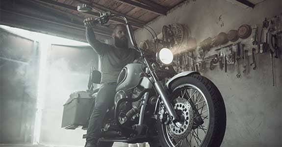 man_on_a_motorcycle_in_a_garage_575x300