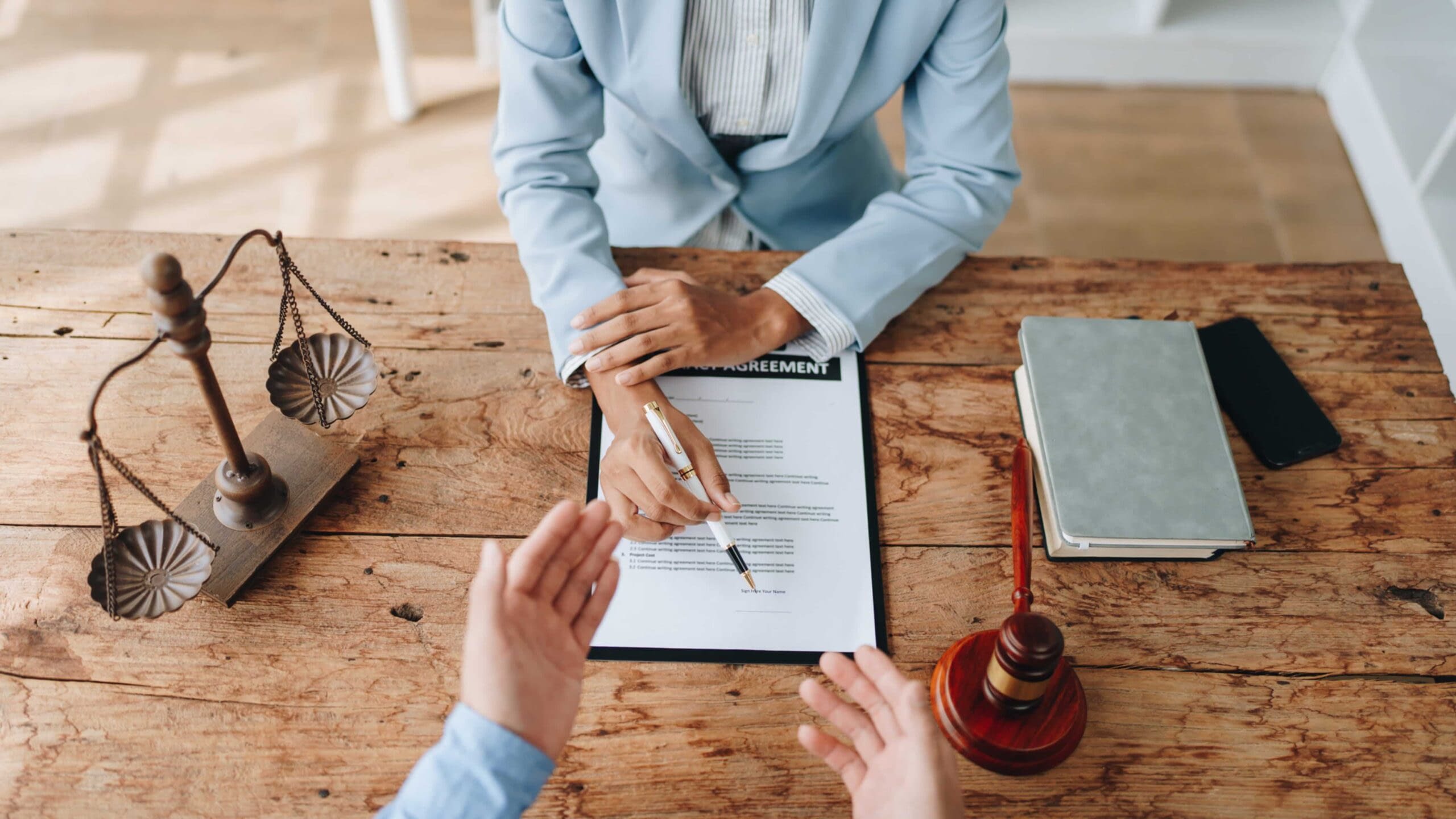7-19 Blog Image woman in suit explaining policy agreement with pen