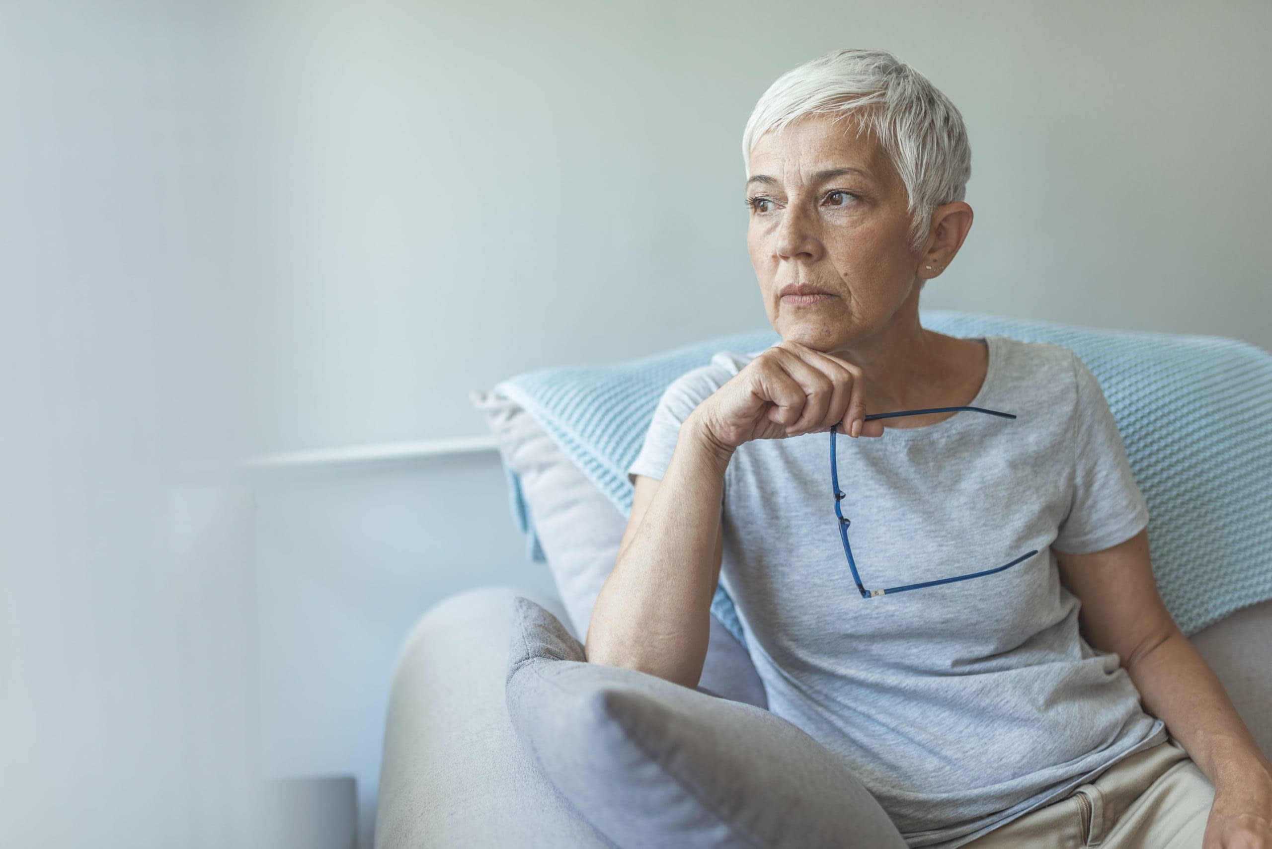 GettyImages-1162818693 senior woman sitting on couch