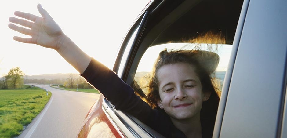 Young Girl With Her Hand Out The Window Out