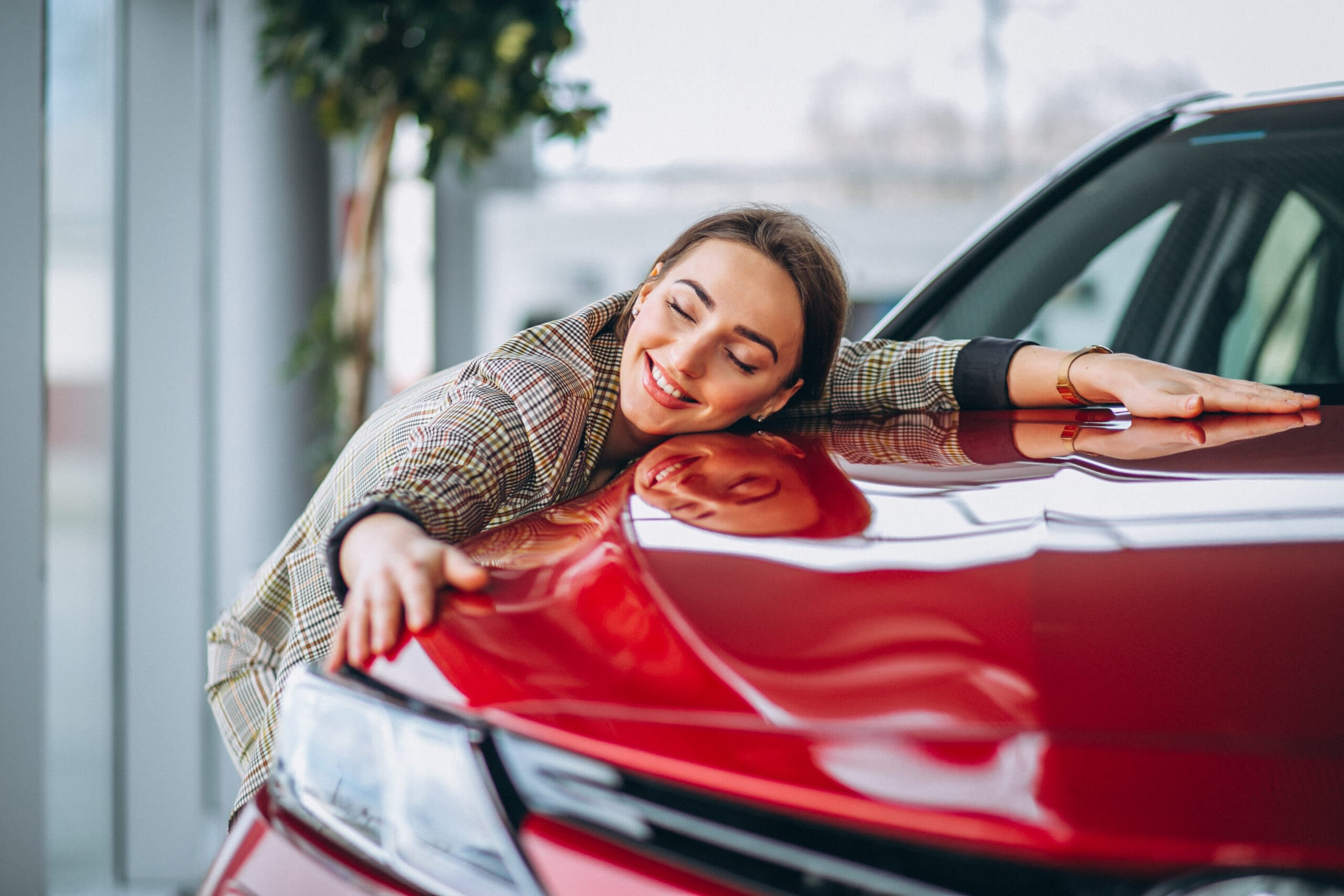 Beautiful woman hugging a car