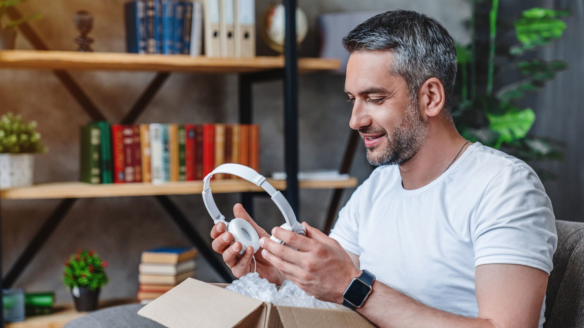 Man unboxing a new pair of headphones.