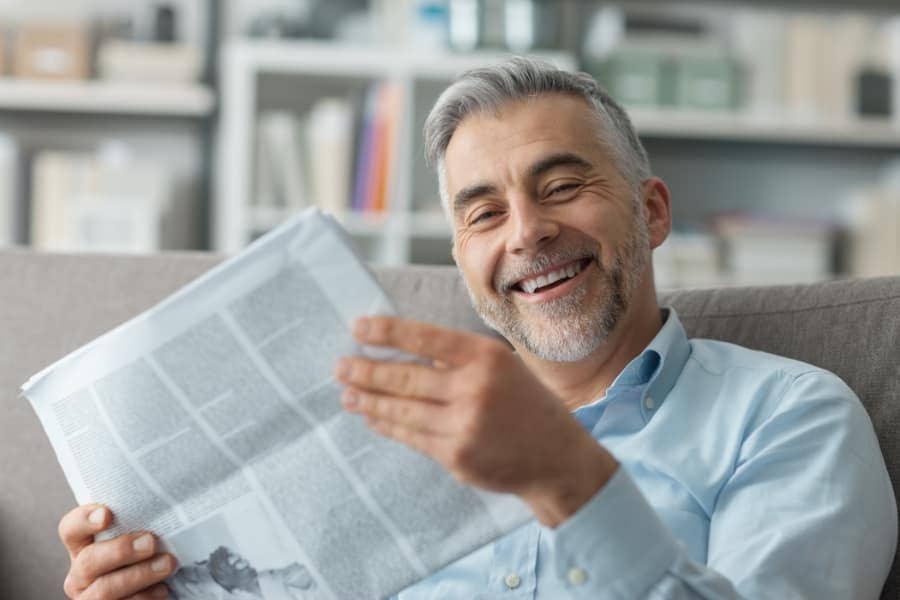 Businessman sitting on the couch and reading news
