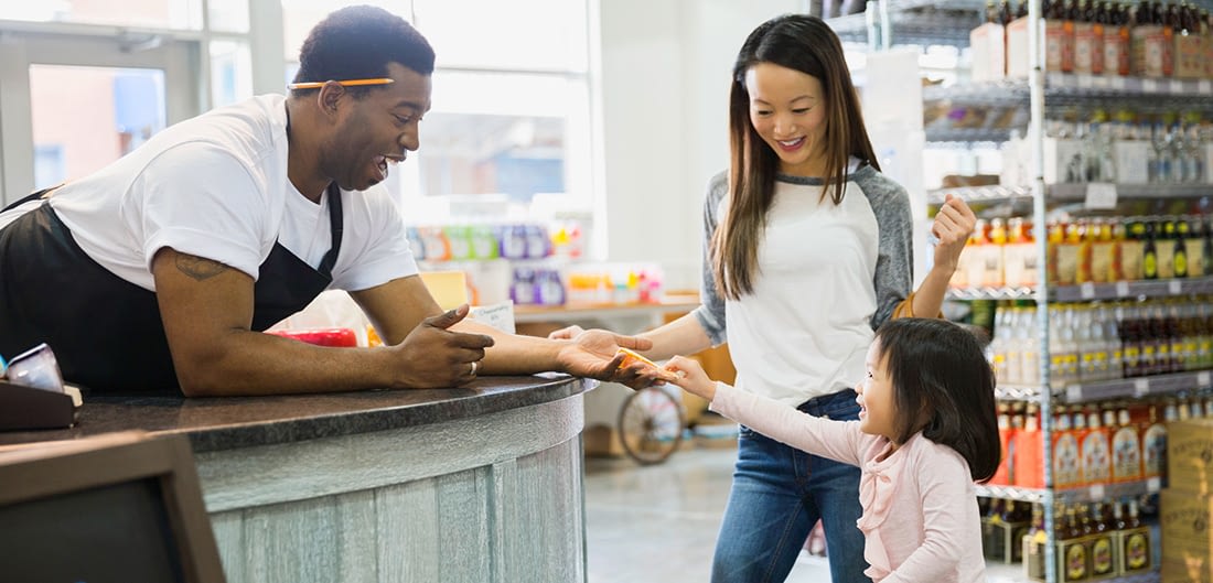 Girl Giving Item To Store Clerk