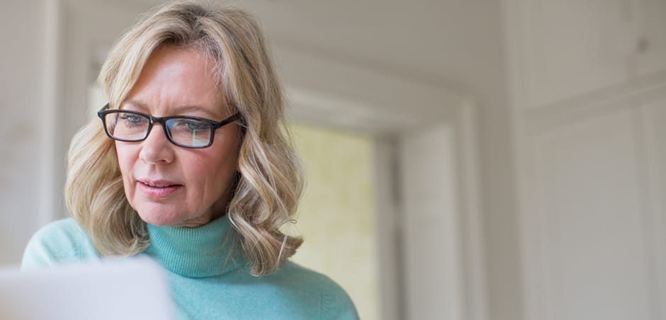 Middle Aged Woman Looking at Paper