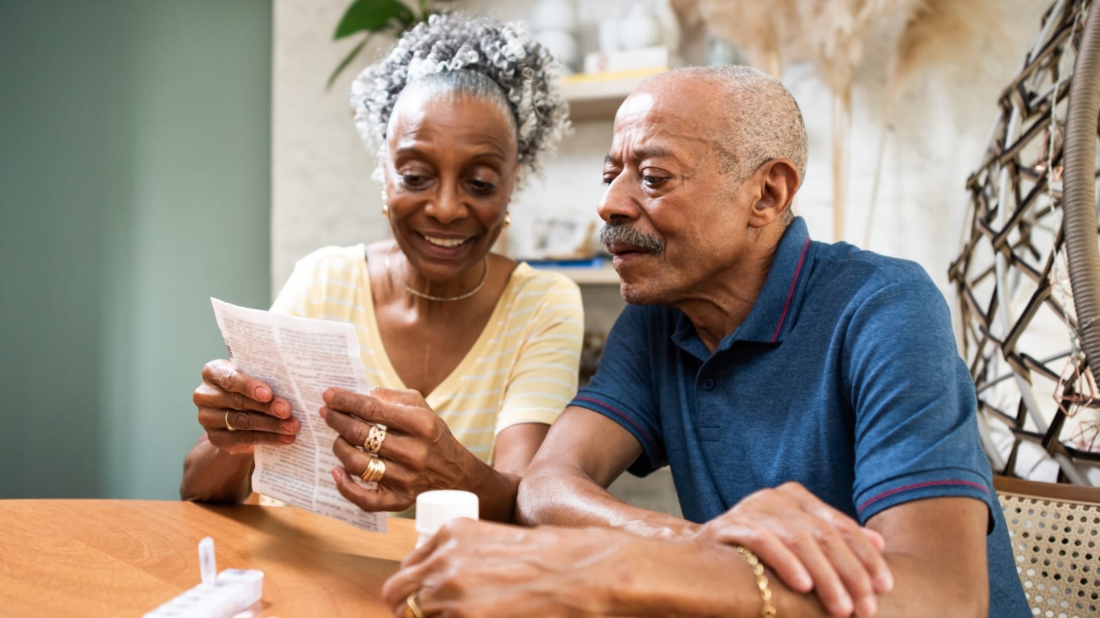 two seniors reading a paper