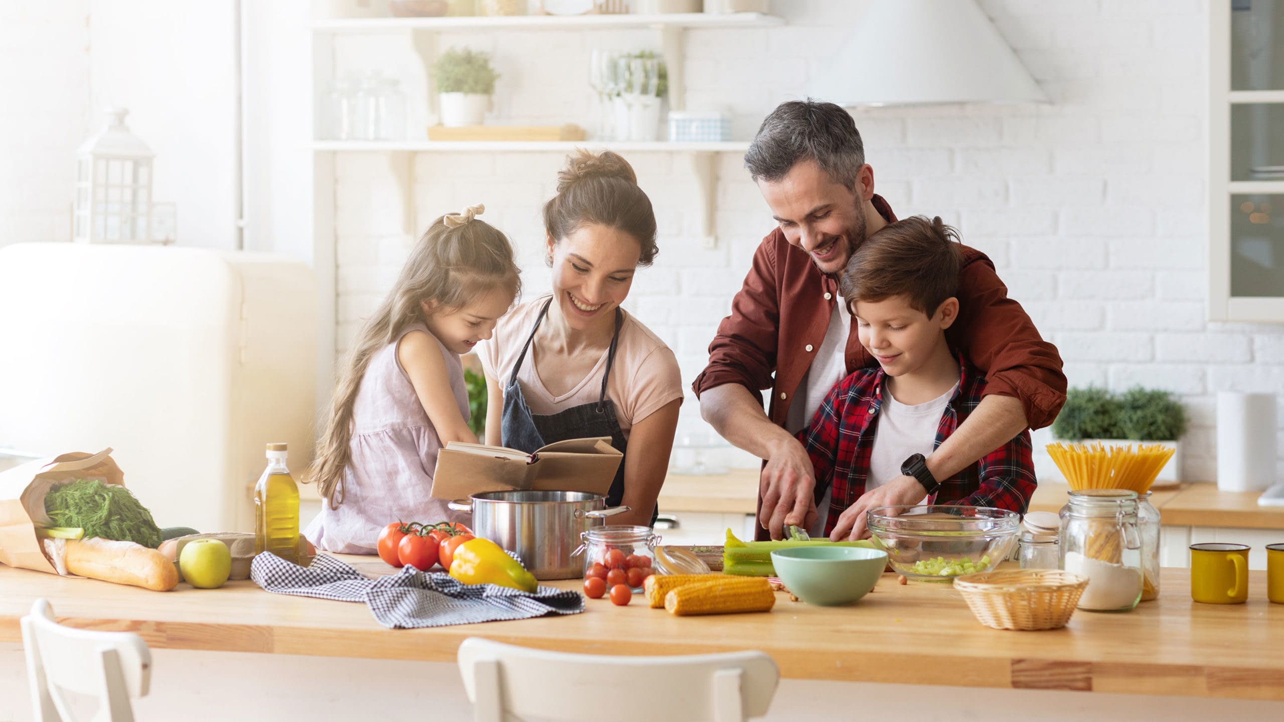 Family preparing a meal together in their kitchen.