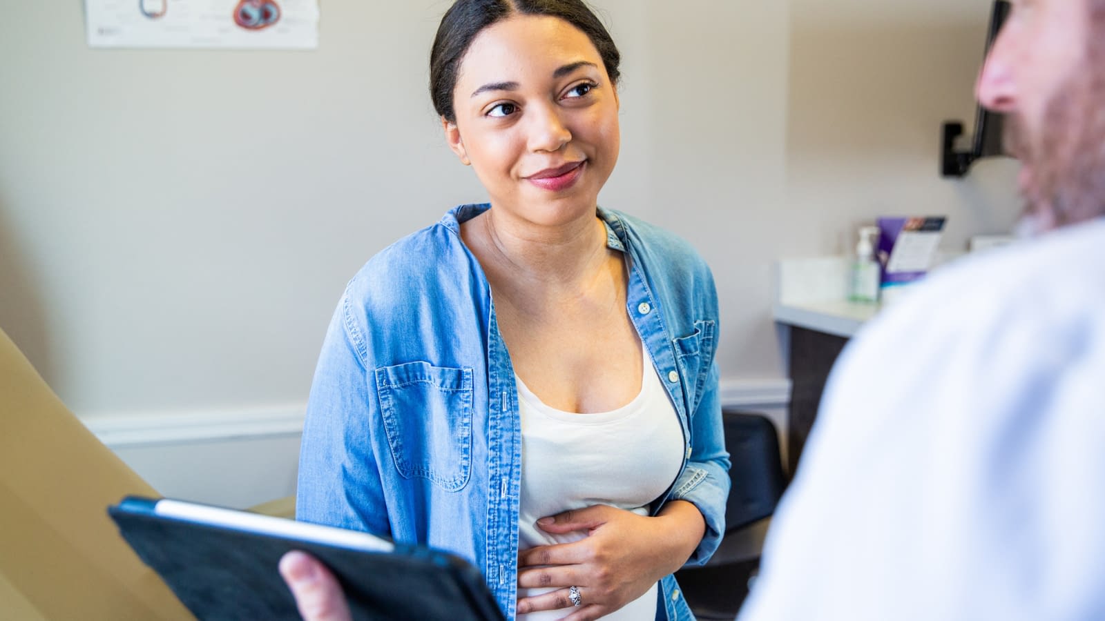 12 Young pregnant woman in hospital office.