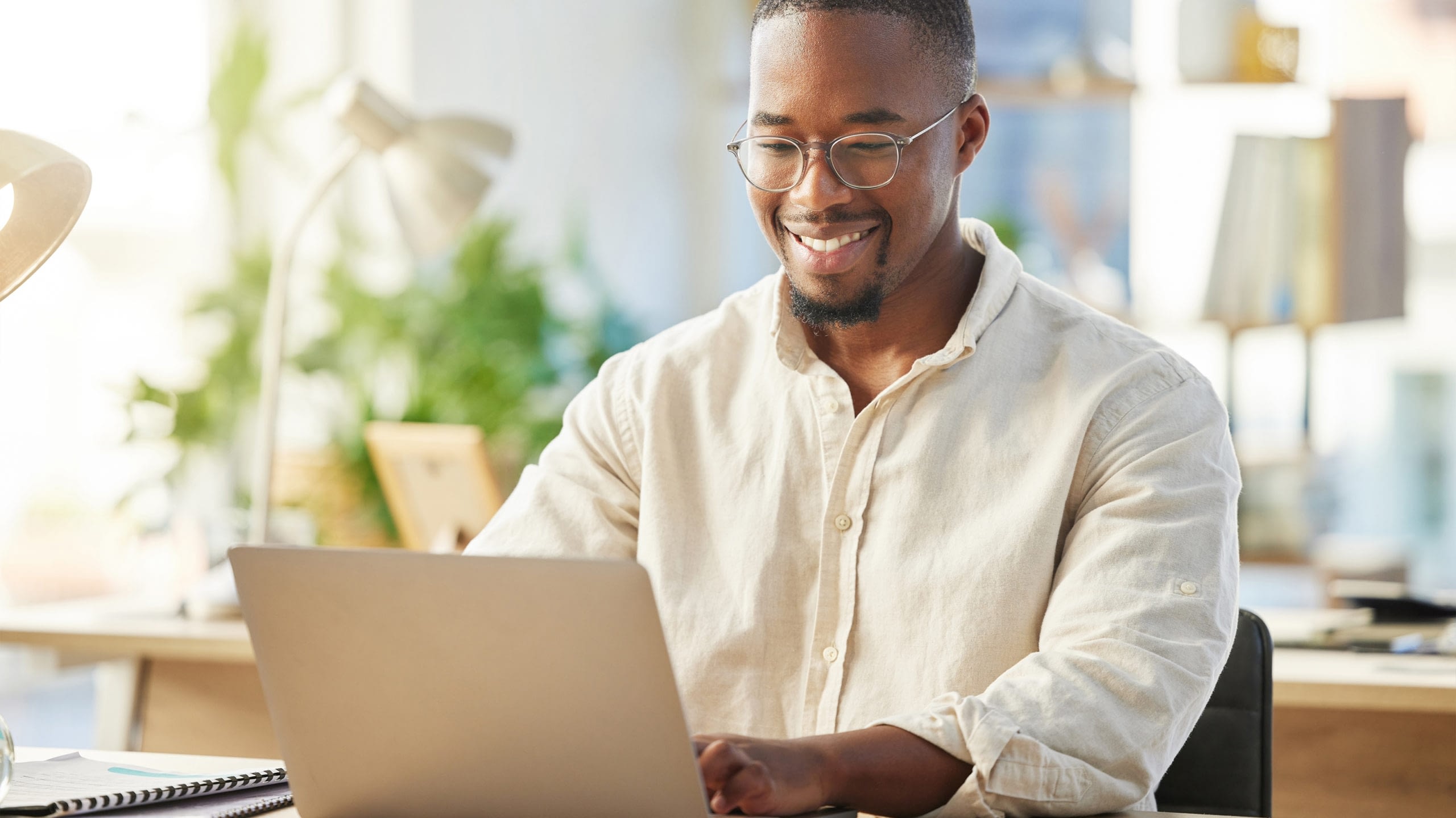 Shot of a young businessman working on his laptop at his desk