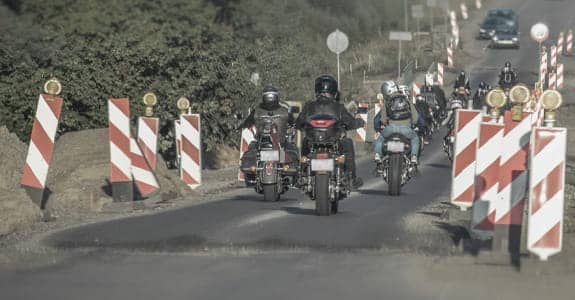 Motorcycles riding through a road construction area