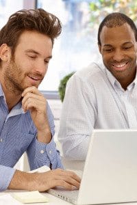 Two Non-Profit Male Employees Working on a Laptop