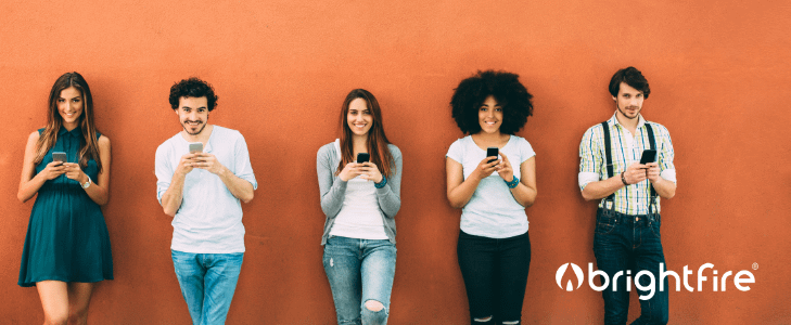 diverse group of people using cellphones