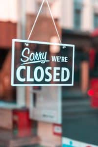 Sorry, We're Closed, sign on the front door of a business.