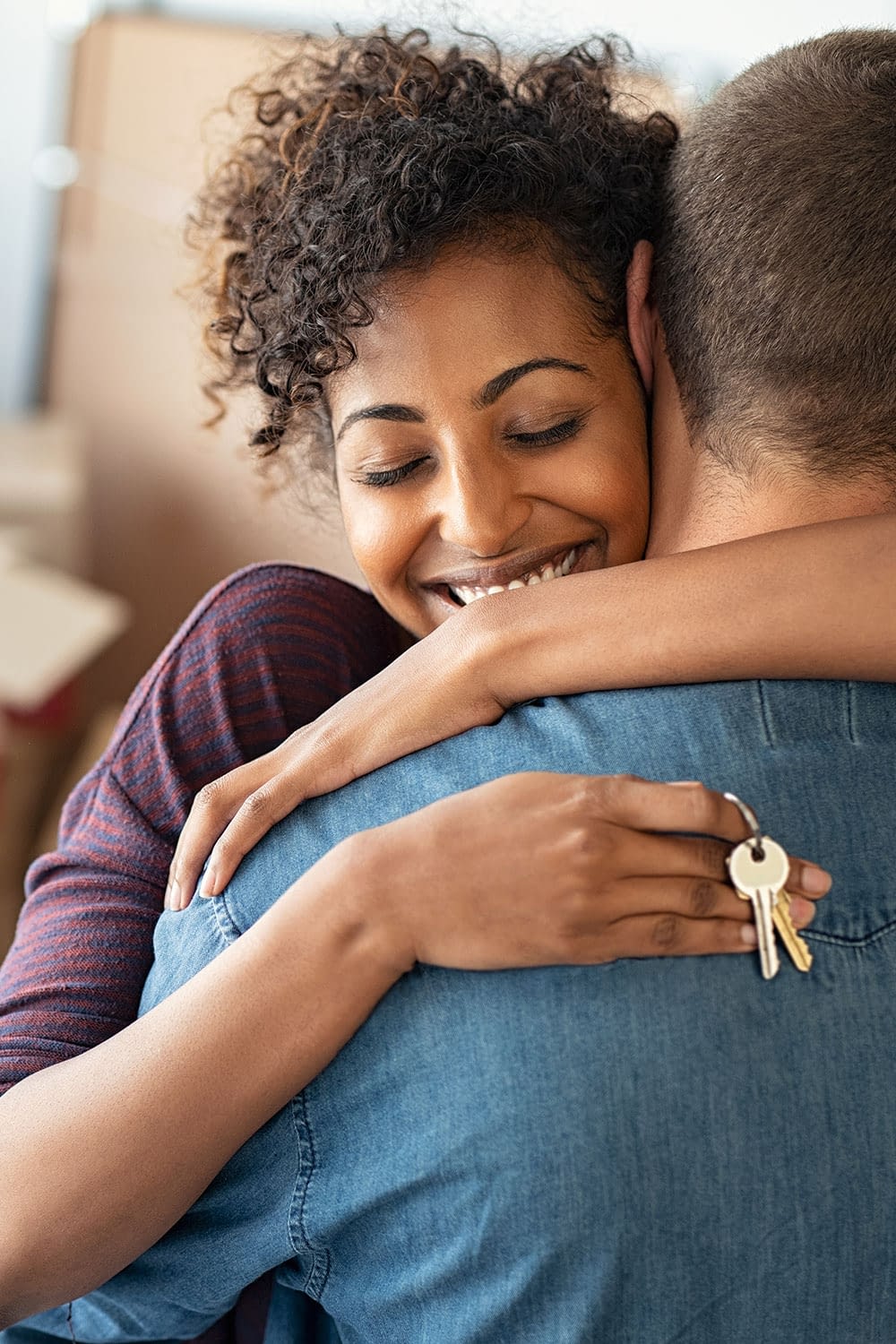 Happy couple embracing each other celebrating the purchase of their new home.
