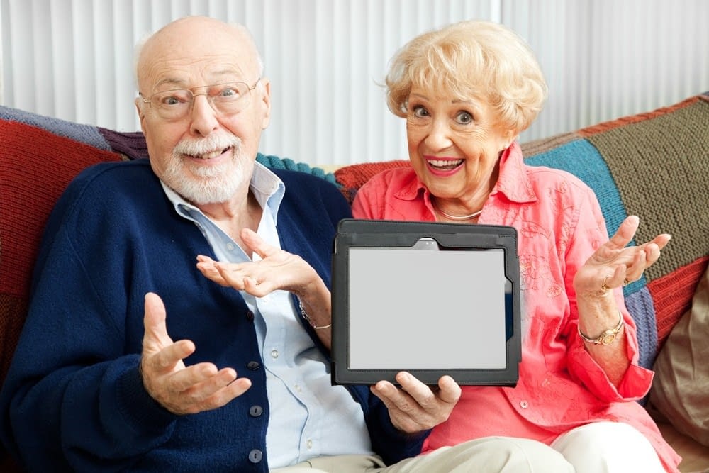 Senior Couple Confused by Tablet PC Confused senior couple holding their new tablet PC. Blank computer screen ready for your text.