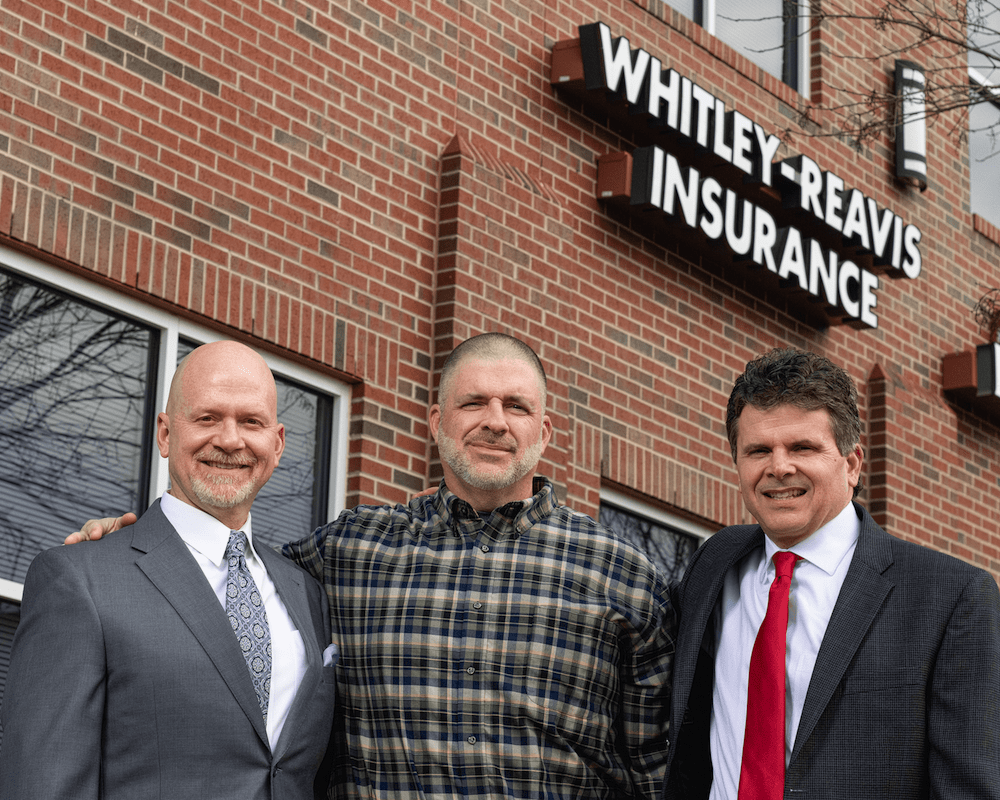 Whitley brothers posing outside office building
