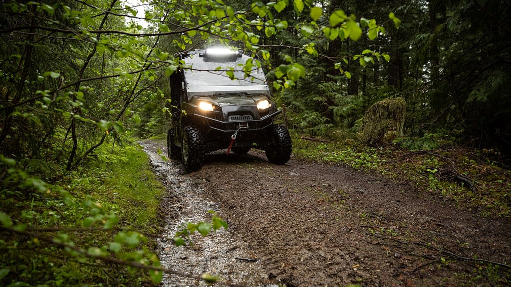 UTV riding on a wet woods trail in Maine
