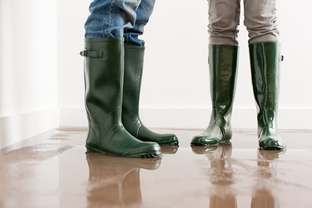close up image of rain boots in a flooded room