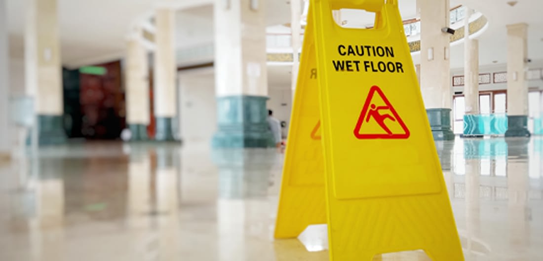 caution sign in corporate office hallway