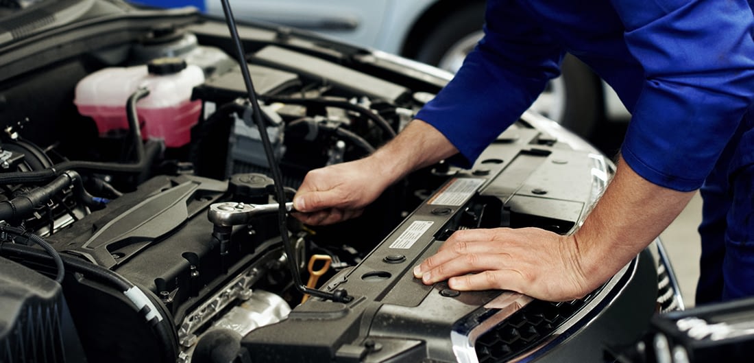 up-close of mechanic repairing a car