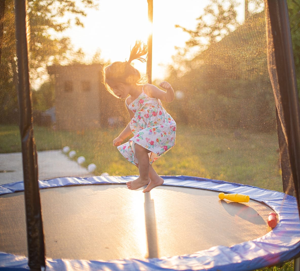 little girl jumping on trampoline