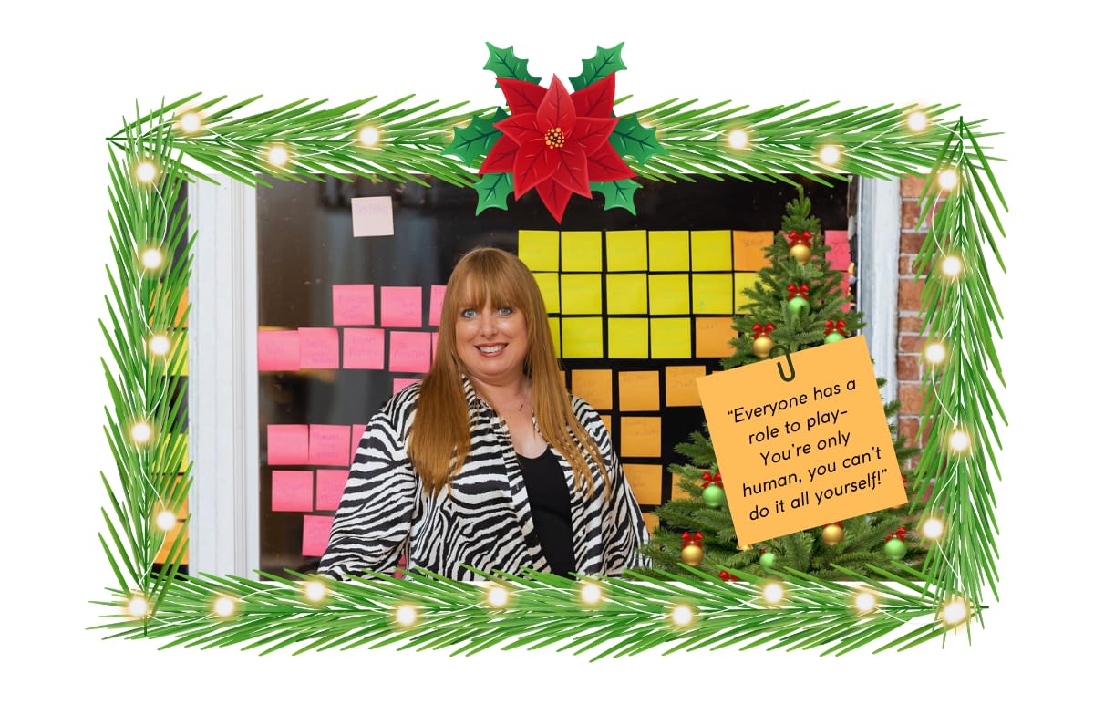 2025 Holiday Hosting Tips from Kelly Kelly posing with her famous post it wall