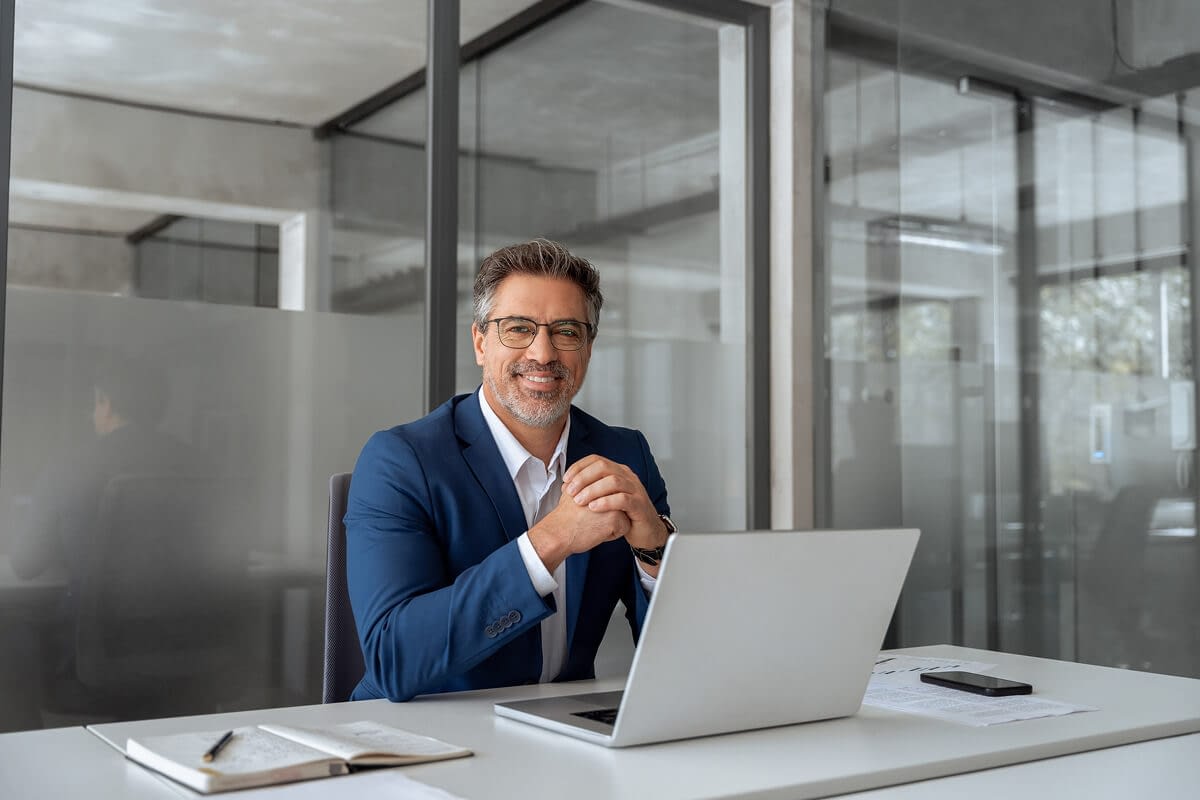 portrait-of-mature-business-man business executive in a nice office on a computer