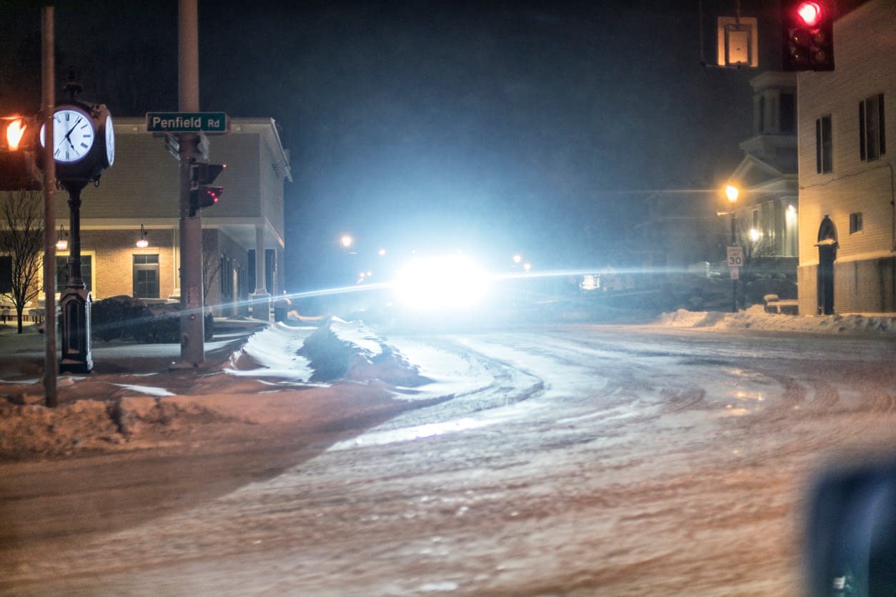Why Today’s Headlights Feel Blinding and How to Stay Safe Blinding Bright Headlights Night Snowplow Truck in Village