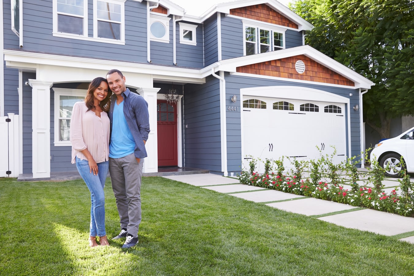 Couple standing outside of house