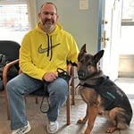Our customer: A United States veteran and his service dog at the George A. Reed Agency