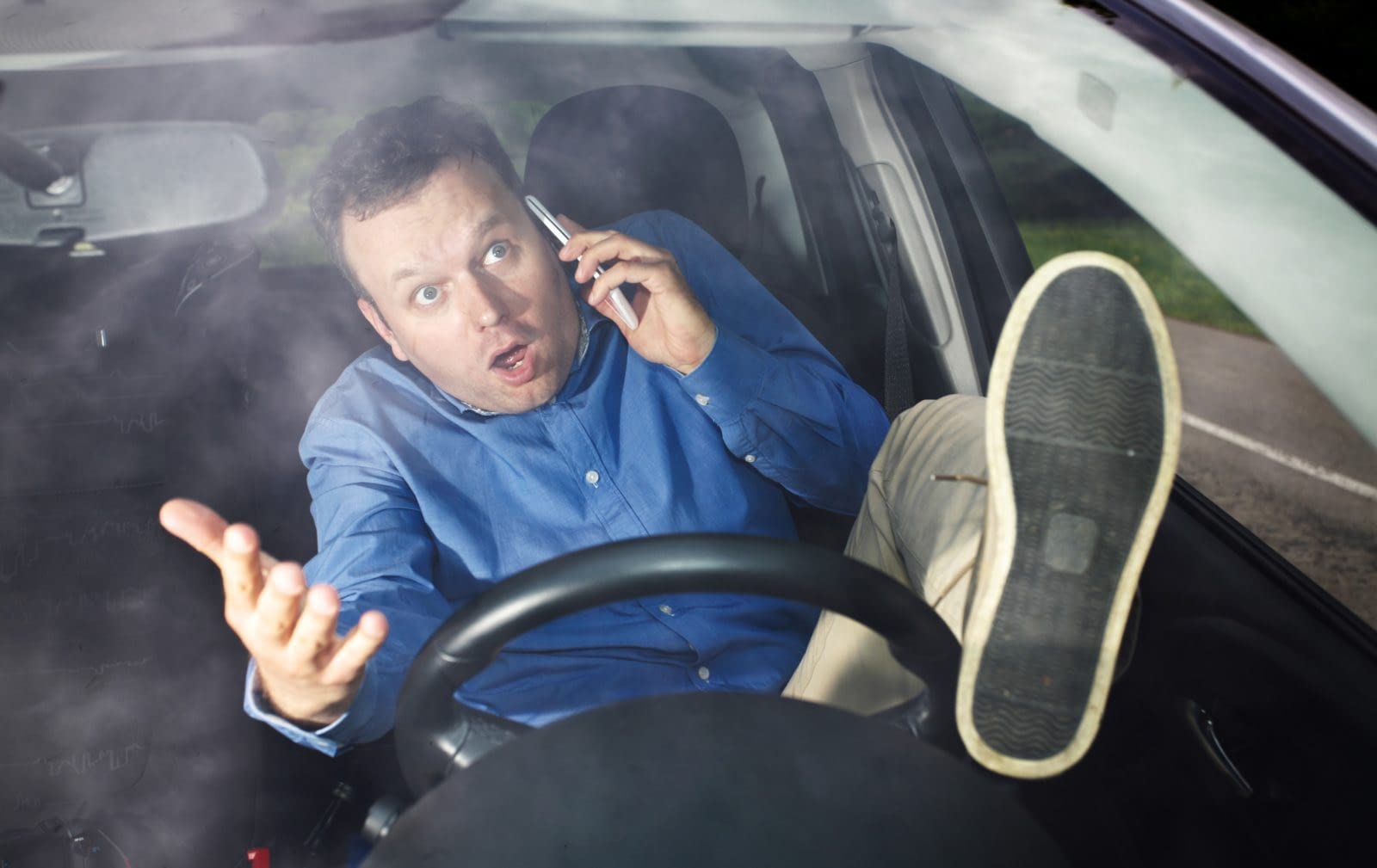 Driver and cellphone Distracted driving is dangerous.