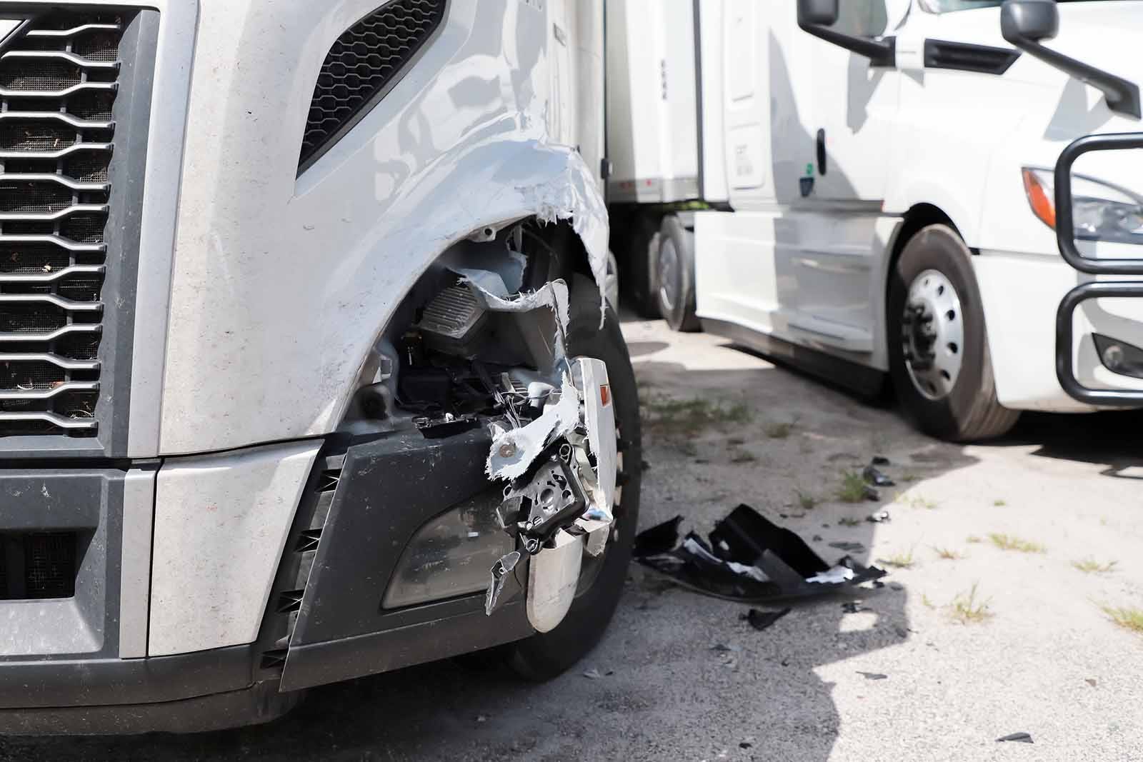 Damage closeup on white truck.