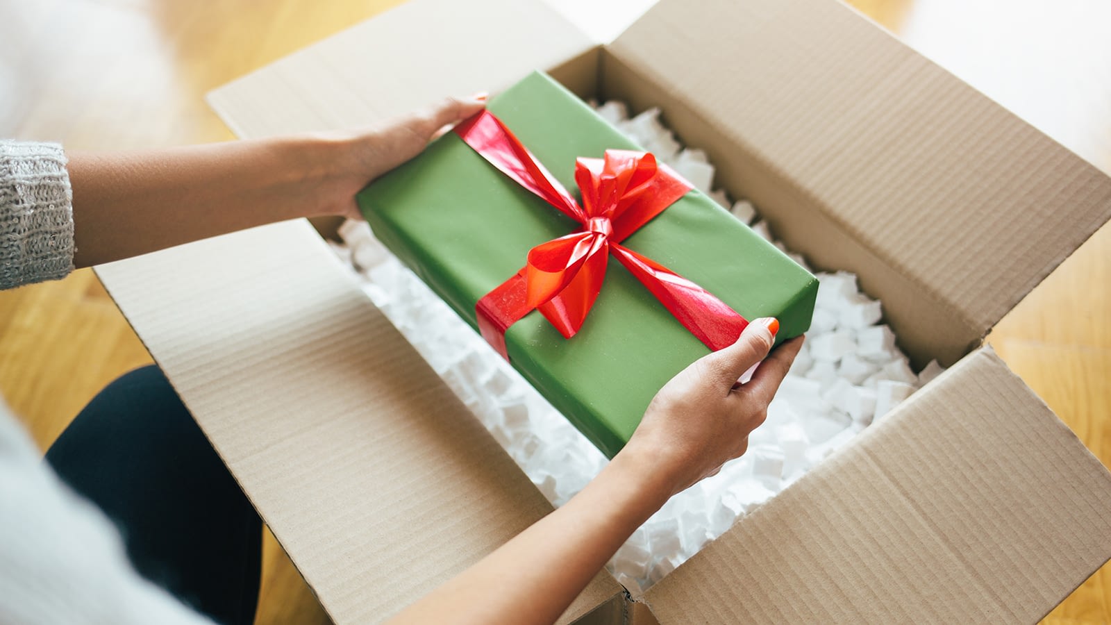 person pulling gift from box