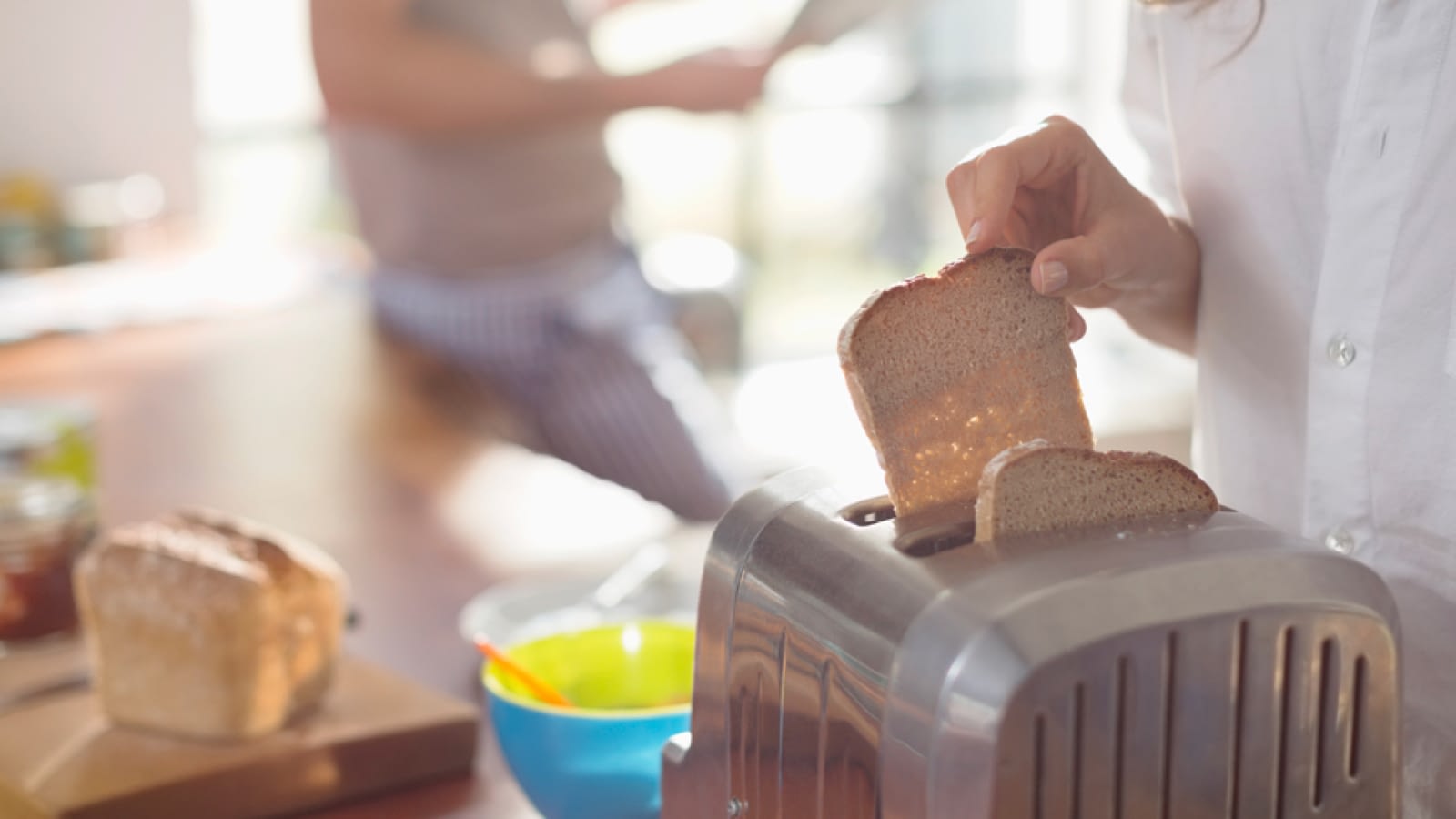 Woman making toast in a new toaster