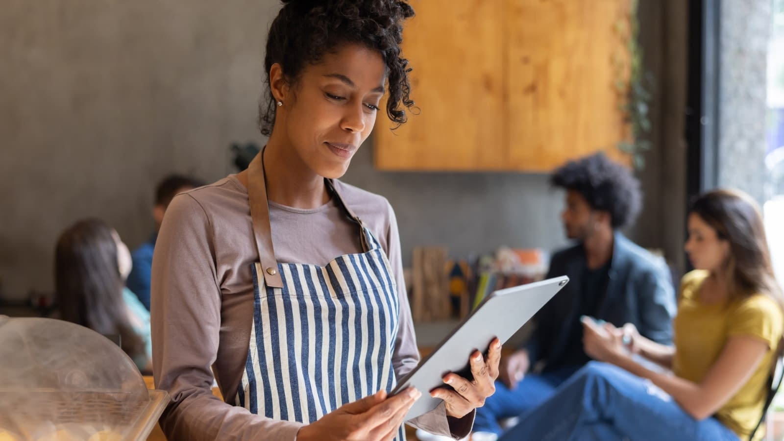 running a business business owner checking her ipad