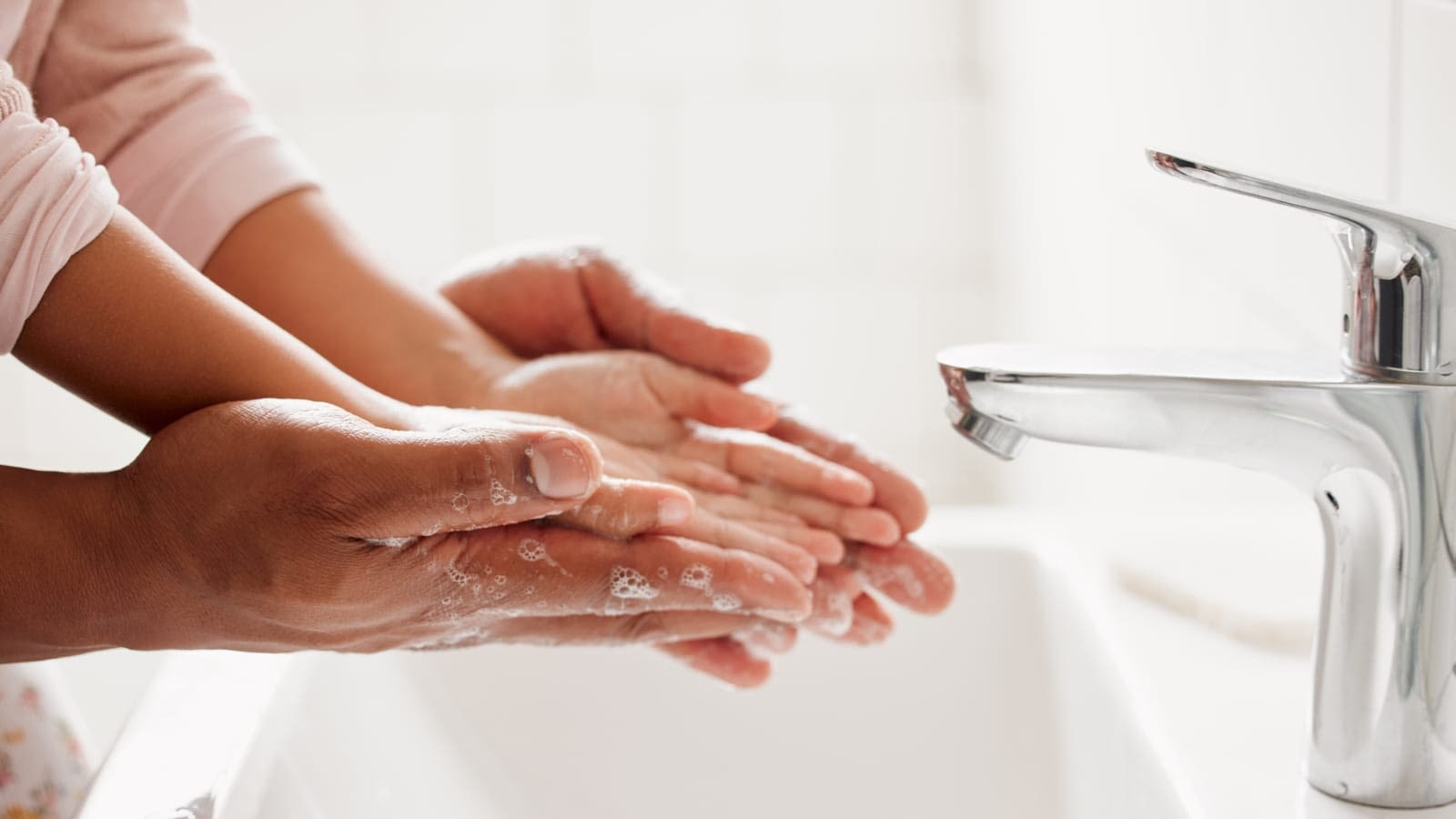 Two people washing hands Parent and child washing hands