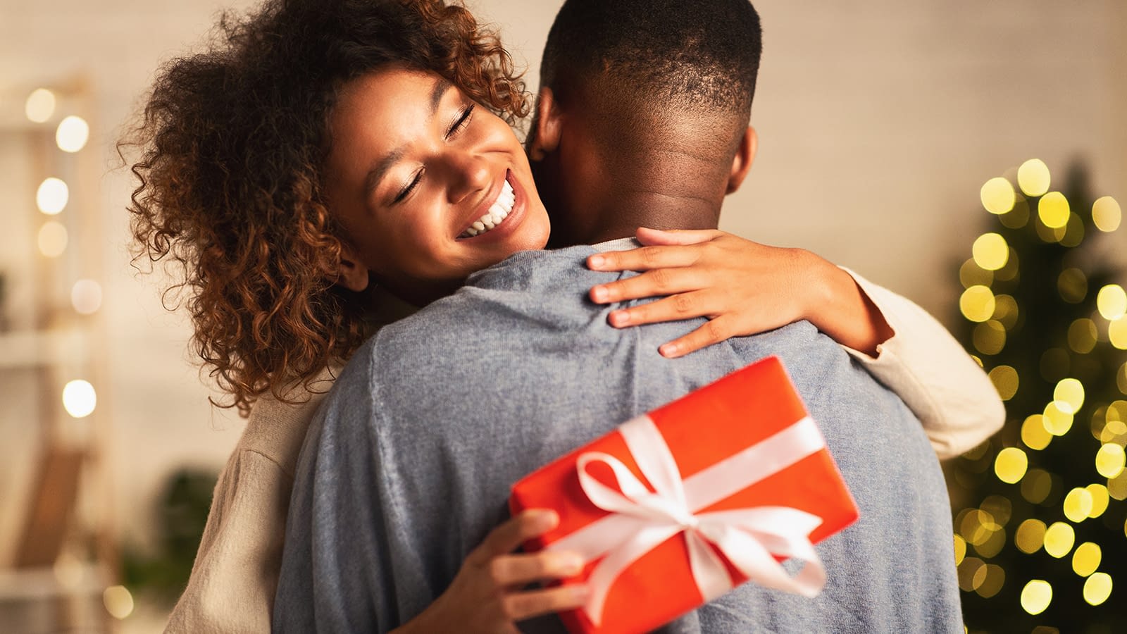 Woman Hugging Man After Getting a Gift Woman hugging man after gift