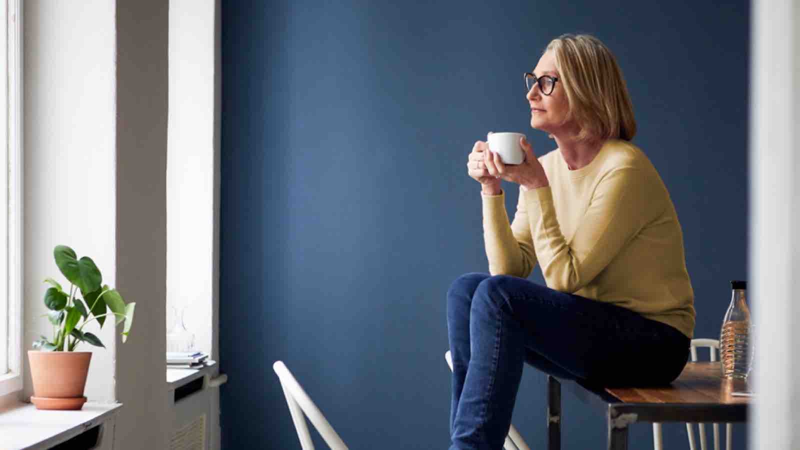 executor-large Older woman drinking coffee and contemplating life