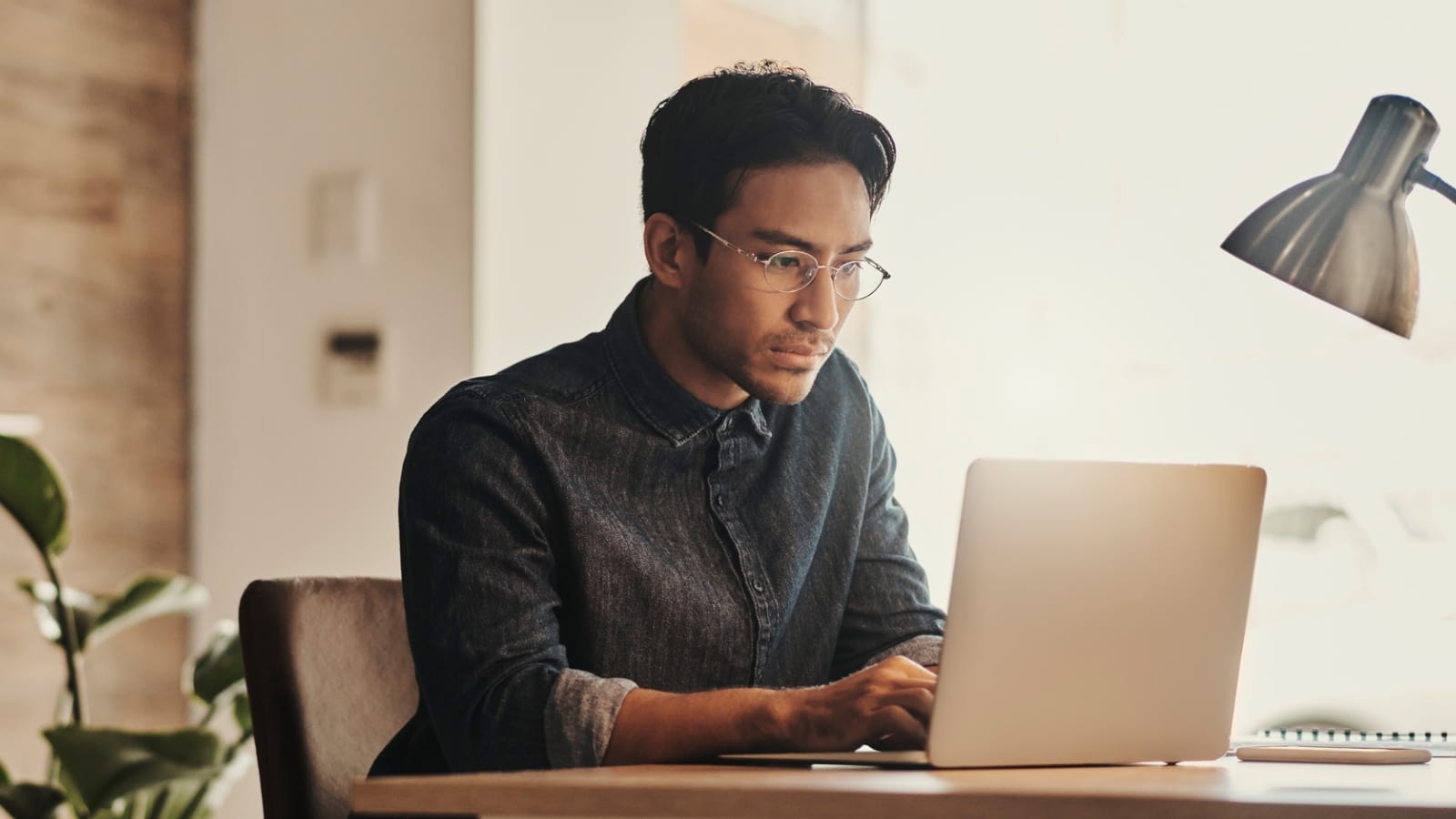 young asian man working on laptop