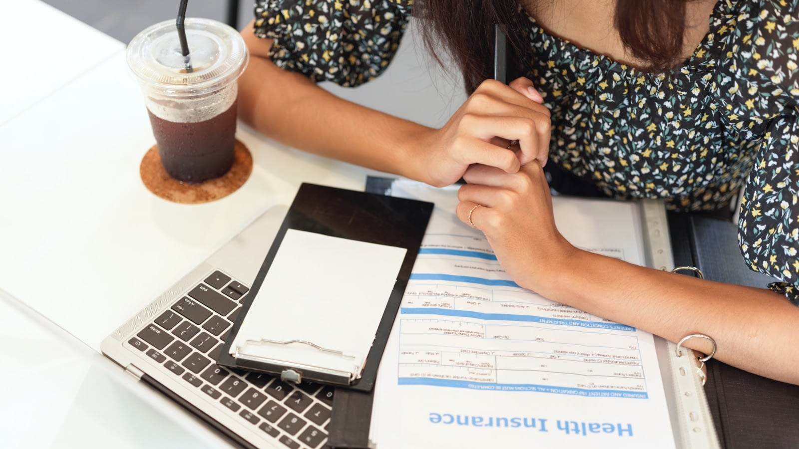 Up-close of young woman perusing health insurance options