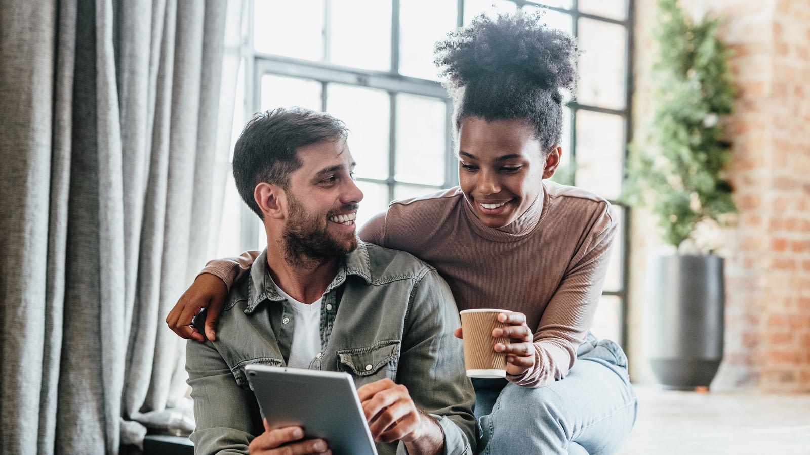 young couple looking at ipad